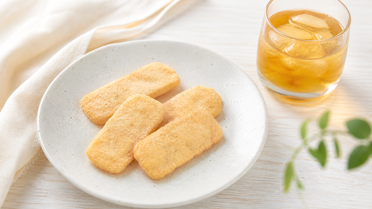 Kinako rice crackers on a plate with cold barley tea, a light everyday snack