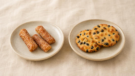 Teriyaki okaki sticks and black bean senbei side by side, two Japanese rice cracker textures