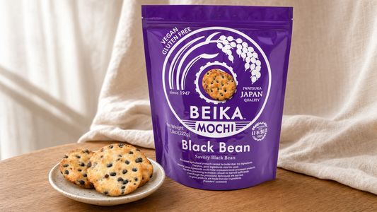 Beika Mochi Black Bean pouch with black bean senbei crackers on a ceramic plate