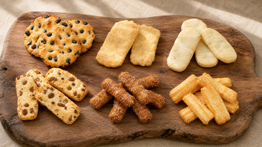 All six Beika rice cracker flavors arranged on a wooden serving board