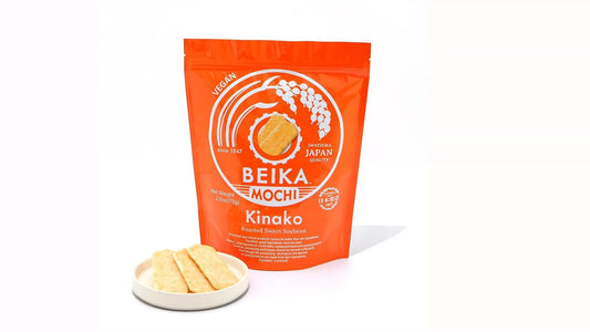 Beika Mochi Kinako 2.6 oz bag beside three kinako rice crackers on a pale ceramic dish