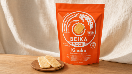 Beika Mochi Kinako pouch with kinako rice crackers on a warm wooden counter